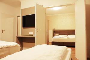 Postel nebo postele na pokoji v ubytování Isar City Hotel