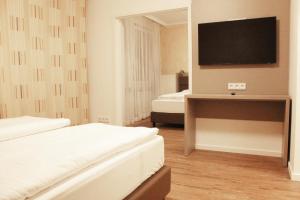 Postel nebo postele na pokoji v ubytování Isar City Hotel