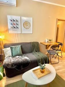 a living room with a couch and a table at Apartment Jenny - Old Town, Free Private Parking, AC in Bratislava