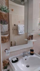 a bathroom with a sink and a mirror and towels at House by the sea/Σπίτι στην θάλασσα in Flámbouras