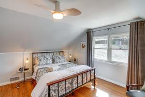 a bedroom with a bed with a ceiling fan and a window at Saugerties Farmhouse with Patio and Countryside Views! in Saugerties