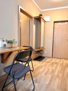 a room with a table and a chair and a desk at Apartment Jenny - Old Town, Free Private Parking, AC in Bratislava