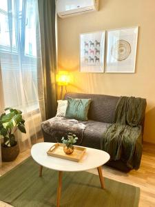 a living room with a couch and a table at Apartment Jenny - Old Town, Free Private Parking, AC in Bratislava