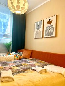 a bedroom with a bed with two towels on it at Apartment Jenny - Old Town, Free Private Parking, AC in Bratislava