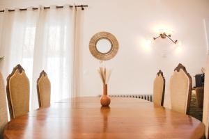 a dining room table with chairs and a mirror at Quiet and bright nest near Perpignan in Pia