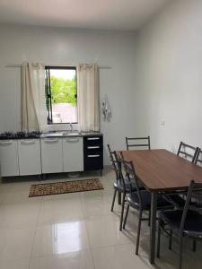 a kitchen with a table and chairs and a window at Apartamento, Salto del Guaira in Salto del Guairá