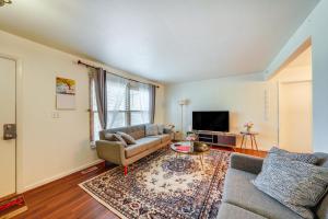 a living room with a couch and a tv at Cozy and Quiet Hanover Park Townhome! in Hanover Park