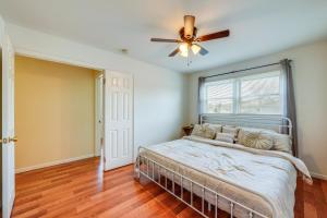 a bedroom with a bed and a ceiling fan at Cozy and Quiet Hanover Park Townhome! in Hanover Park
