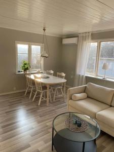 a living room with a couch and a table at A nice little cottage in Henån in Henån