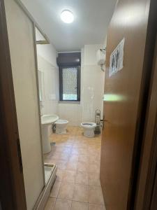a bathroom with two toilets and a sink at RAHIMA GUEST HOUSE in Rome