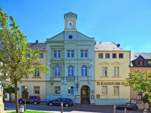 a building with a clock tower on top of it at Rathaushotel in Eibenstock