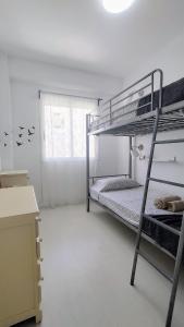 Zimmer mit 2 Etagenbetten und einem Schreibtisch in der Unterkunft Casa Canaria shared house in El Médano