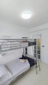 a white room with two bunk beds in it at Casa Canaria shared house in El Médano