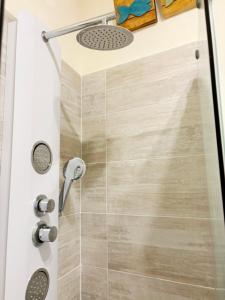 a shower in a bathroom with a shower head at Medinat House in Catania