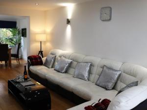 a living room with a white couch with pillows at No 1 Ashey in Ryde +34 photos