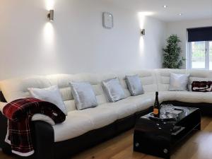 a white couch with pillows on it in a living room at No 1 Ashey in Ryde