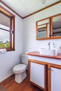 a bathroom with a toilet and a sink at Refugio San Antonio - 1500 acre Private Preserve in Guaria