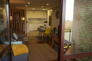a living room and kitchen with a couch and a table at Zelaia in Mendexa