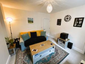 a living room with a couch and a coffee table at Palmer House Apartment in Ryde