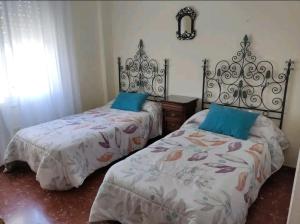 Duas camas sentadas uma ao lado da outra num quarto em Piso primera línea de playa em Chipiona