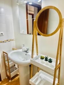 a bathroom with a sink and a mirror at Apartamento en Santander in Santander