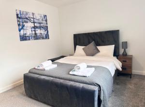 a bedroom with a bed with two towels on it at All Inn Apartments in Staveley
