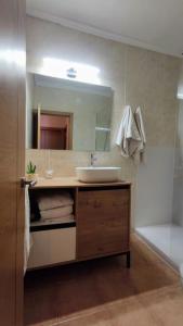 a bathroom with a sink and a mirror at ¡Espectacular apto con vistas al mar con Wifi! in Comarruga +22 photos