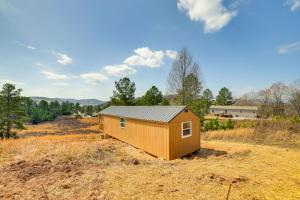 a tiny house in the middle of a field at Cozy Decatur Cabin with Views about 1 Mi to Riverfront! in Decatur