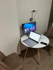 a white table with a laptop and a computer monitor at HOTEL PARIS in Batumi