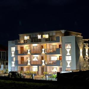 a large building with lights on it at night at Akhard Haus in Buea