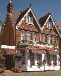 a large brick building with flowers in front of it at Kingsley Hotel in Bournemouth