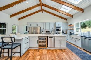 a kitchen with white cabinets and a wooden ceiling at Chianti by AvantStay Stunning Secluded Ranch in Cloverdale