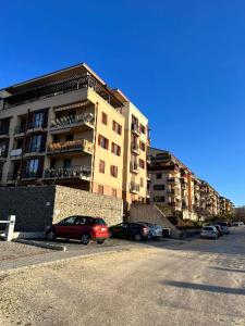 a parking lot with cars parked in front of a building at DunaVera Apartman in Budapest