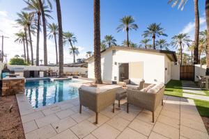 a backyard with a swimming pool and palm trees at Roma by AvantStay Stylish Oasis w Private Pool in Phoenix