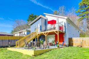 a house with a large deck with chairs on it at Chic Spacious AVL Oasis with Hot Tub and Fire Pit in Asheville
