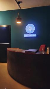 a reception desk with a sign on a blue wall at Tulip Homes by The Oaks Inn in Cochin
