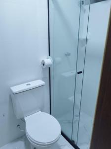 a bathroom with a toilet and a glass shower at LONDRES HOTEL in Gama