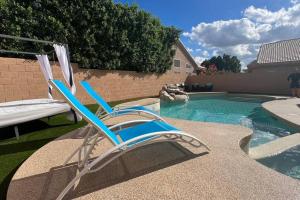 a blue and white chair sitting next to a swimming pool at Rejuvenate Yourself at this Arizona Home in Scottsdale