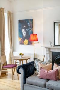 a living room with a couch and a table at Berkeley Suites in Bristol