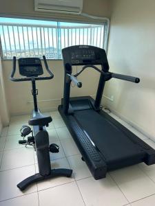 a gym with a treadmill and a exercise bike at Green Hotéis in Cabo Frio