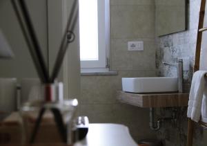 a bathroom with a white sink and a window at Il Fungo di Lacco in Ischia