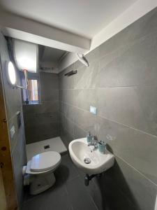 a bathroom with a white sink and a toilet at bilocale arredato sestri ponente in Genova