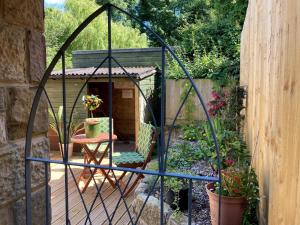 a garden gazebo with a table in a garden at Squirrels Nest - Pet Friendly in Rookley