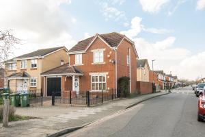 a red brick house on the side of a street at Orchard House: 4 Bed/3 Bath in Thamesmead in London