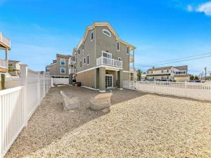a large house with a white fence in front of it at Spectacular 6 Bedroom Home On The Oceanblock In Beach Haven!!! Hot Tub!!! in Beach Haven