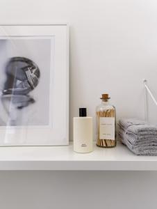 a bottle of perfume sitting on a shelf next to a picture at Magnifique appartement - Quartier Louise! in Brussels