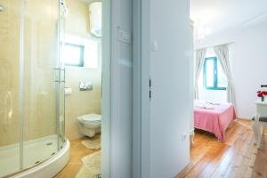 a bathroom with a shower and a toilet and a bedroom at Villa Tereza with Private Pool Sea View in Mlini