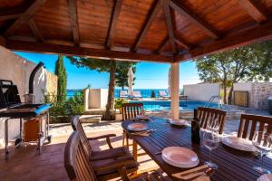 a patio with a table and chairs and a pool at Villa Tereza with Private Pool Sea View in Mlini