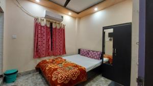 a small bedroom with a bed and a window at GRG M S M Residency Puri in Puri