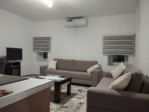 Sala de estar con 2 sofás y mesa en ERTEO Guest House, en Pogradec